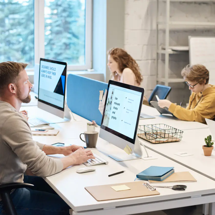 Engineers working together at a shared desk